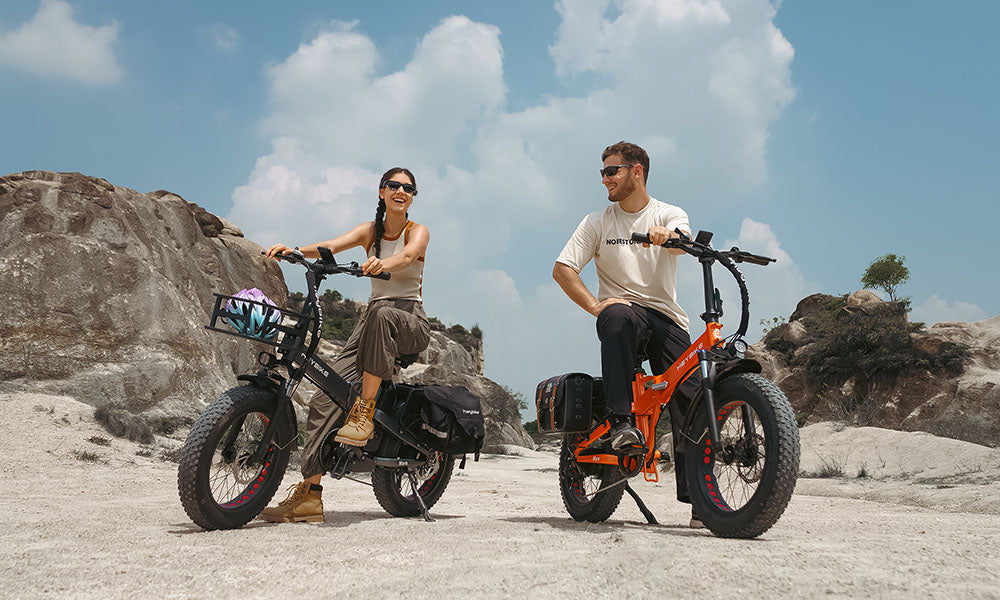 The man and the girl are riding a Mars 2.0 folding e-bike outside