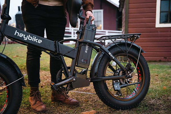 a man is remove battery from Mars ev bike