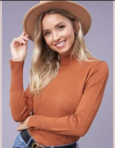 woman in brown blouse and hat