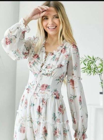 Woman in floral long sleeve short ruffle dress