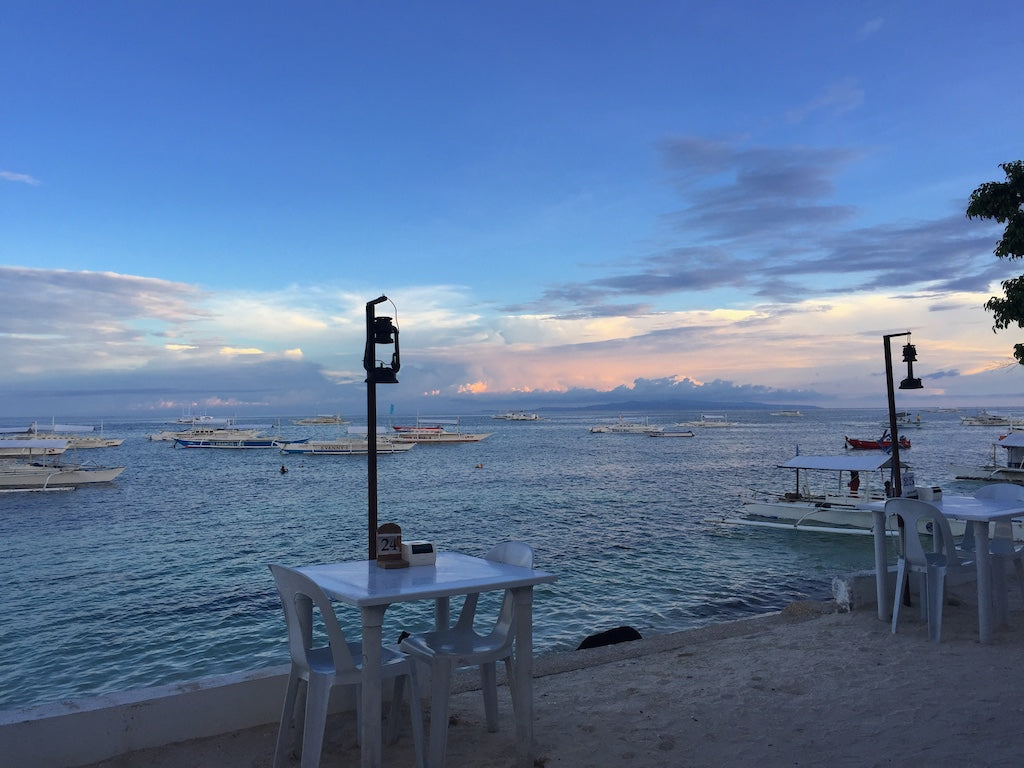 Quiet dinner venue on Alona Beach Bohol Philippines overlooking boats in the water