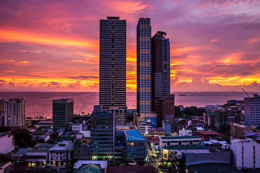 Pink and orange sunset with the buildings along Manila Bay Philippines