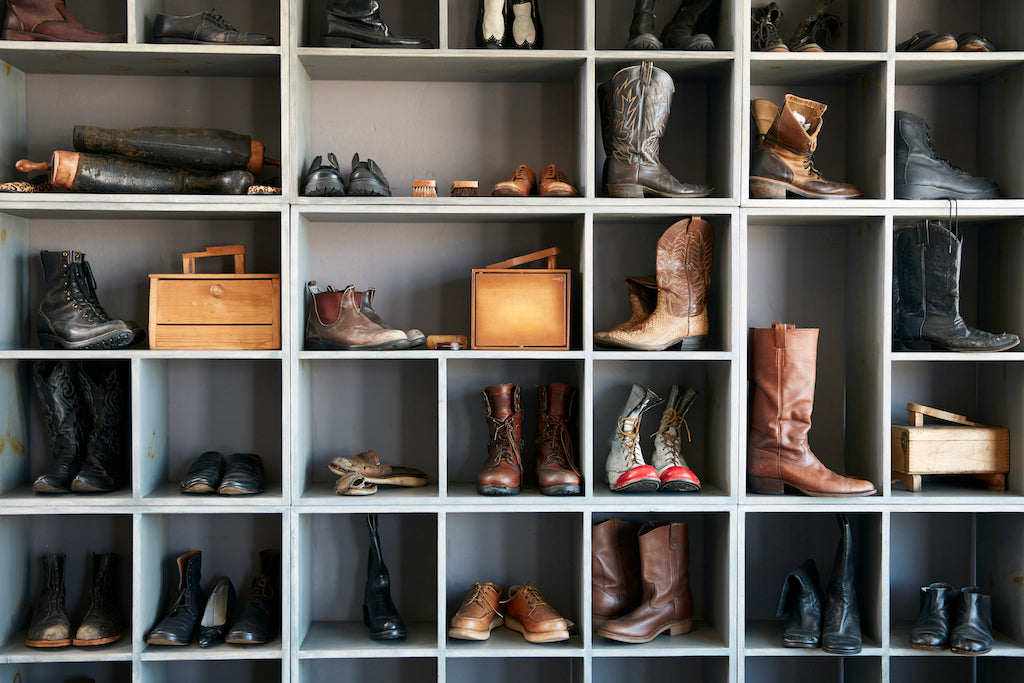 Cowboy boots organized in a storage furniture