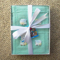 Sheep Dreamzzz green baby blanket in a clear-lid box with a white ribbon