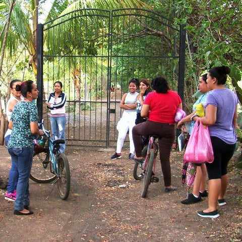 Sheep Dreamzzz knitters in Nicaragua waiting outside a farm gate for their daily knitting time