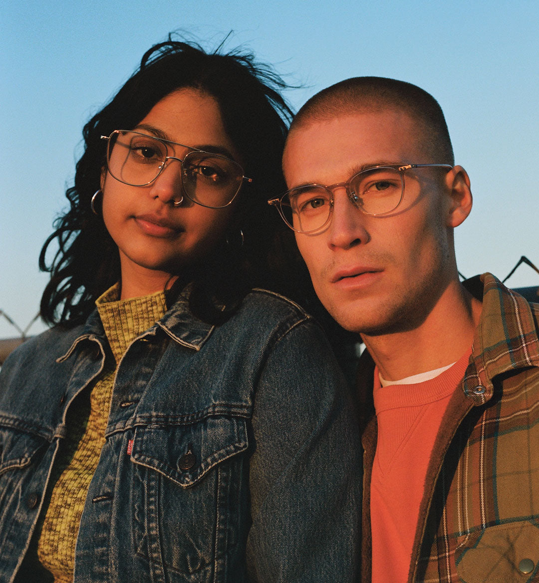 Female and Male wearing trendy JINS glasses under the sun.