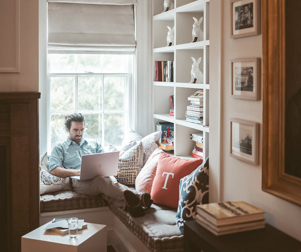 Man on laptop in home nook