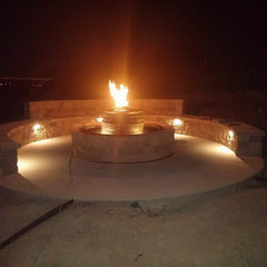 Backyard fire pit lit at night