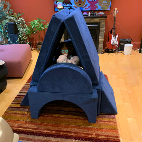 navy blue play couch in the shape of an a-frame house