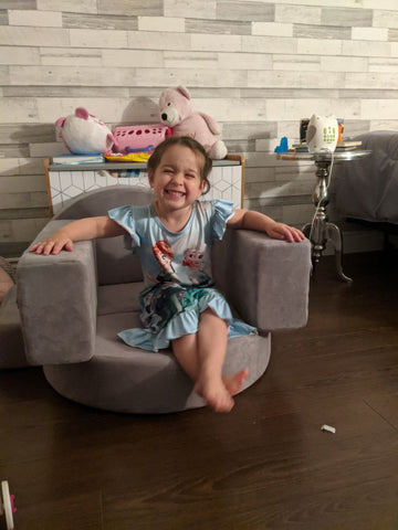 little girl sitting on a play couch in a small chair play couch build