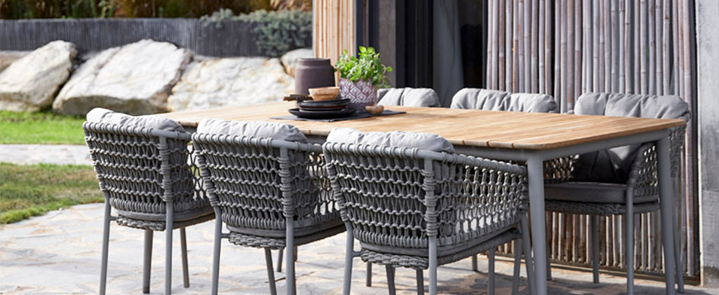 Cosy outdoor space with comfortable outdoor dining chair and teak dining table