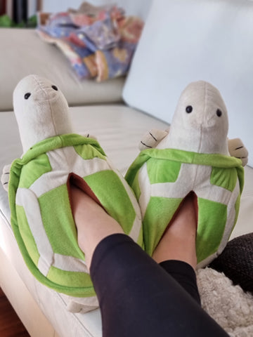 Person wearing warm turtle slippers