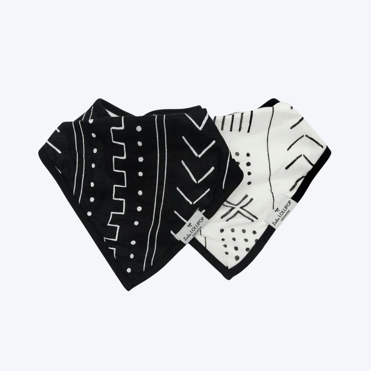 A set of black and white printed bibs by Loulou Lollipop