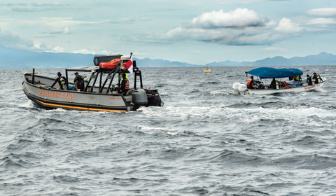 Two boats managing the mariculture fish farms where Open Blue Cobia is raised 