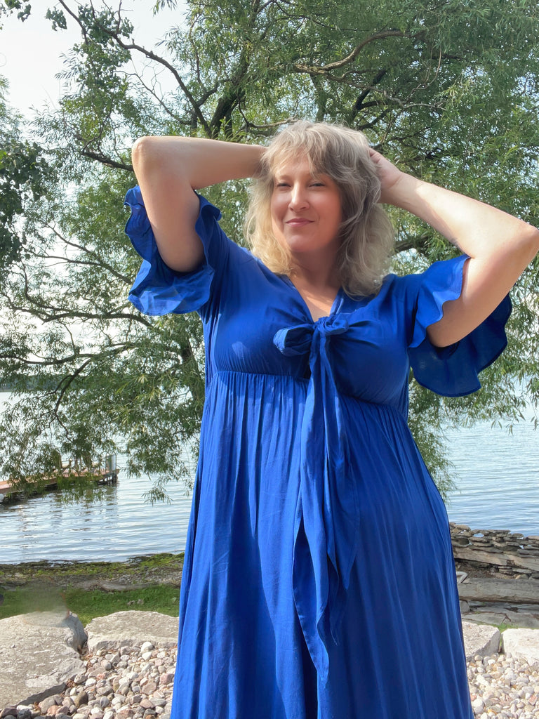 author in a royal blue maxi dress