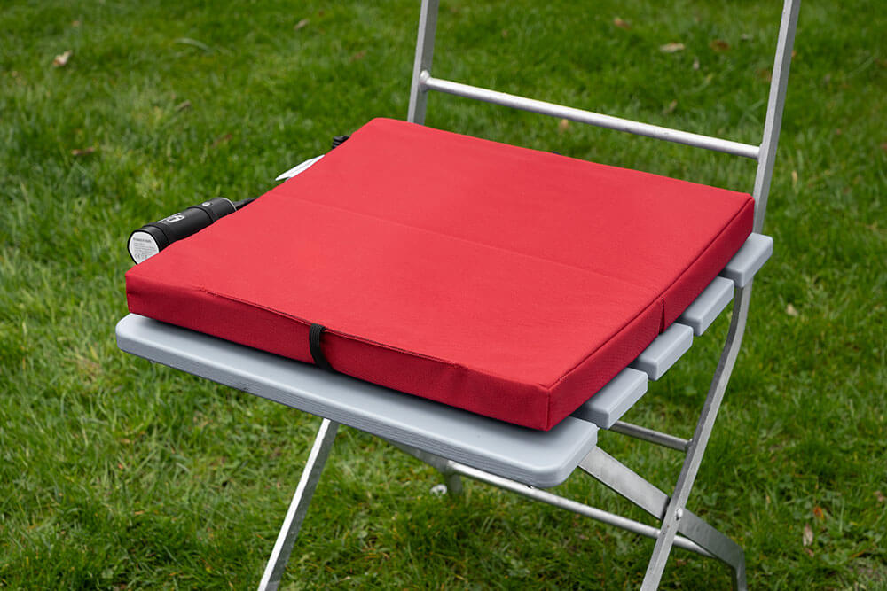 A warm seat pad on a camping chair or garden furniture. Ideal for campers.