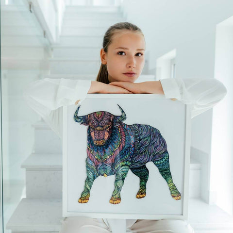 Girl showing picture with wooden bull puzzle and white stairs