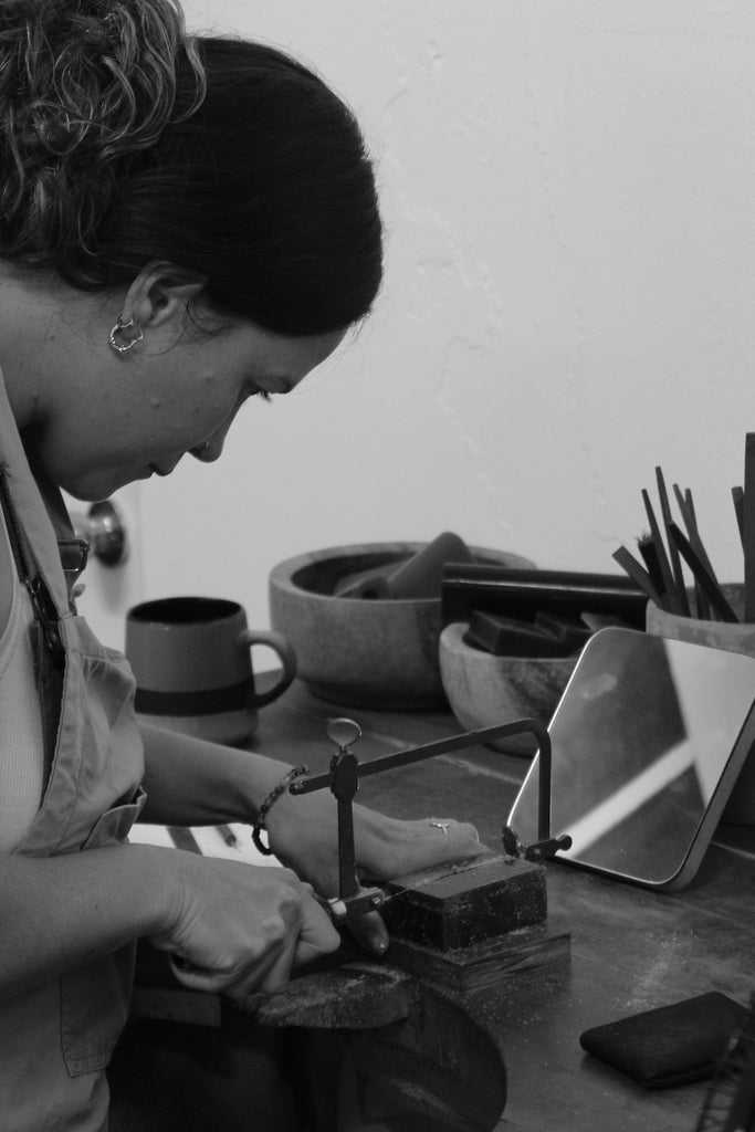 CLUB - Daniela cutting a piece from a wax block