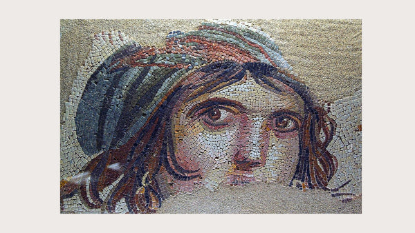 Roman mosaic of a youth's eyes and curly hair