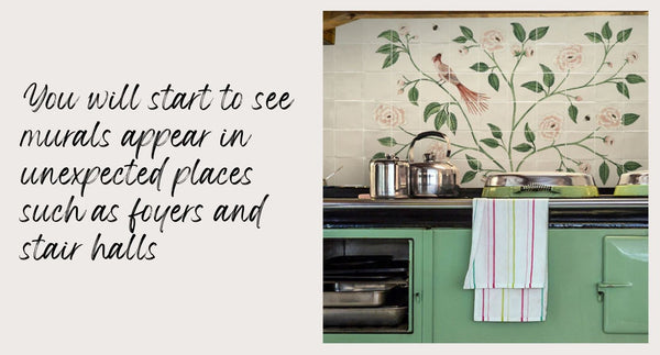Floral tiled mural behind a green aga and kitchen