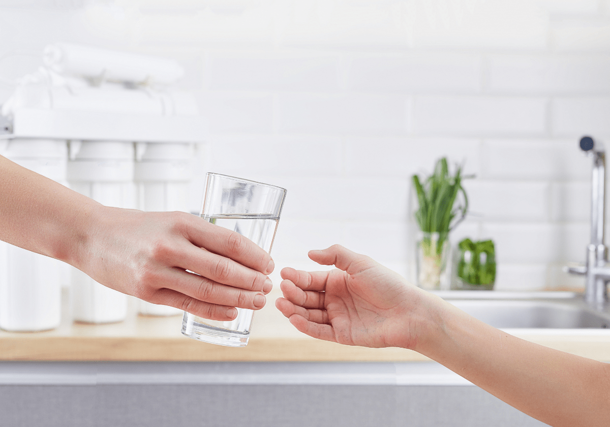 a hand holding a glass of water