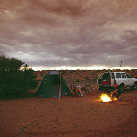 People camping in the outback with a patrol 