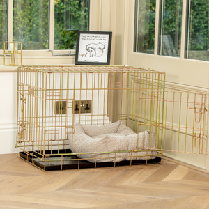 A mink Bouclé cozy and calm bed in a gold cage