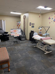 Clinic for electrologist with bed, massage chair, explanatory posters about electrolysis