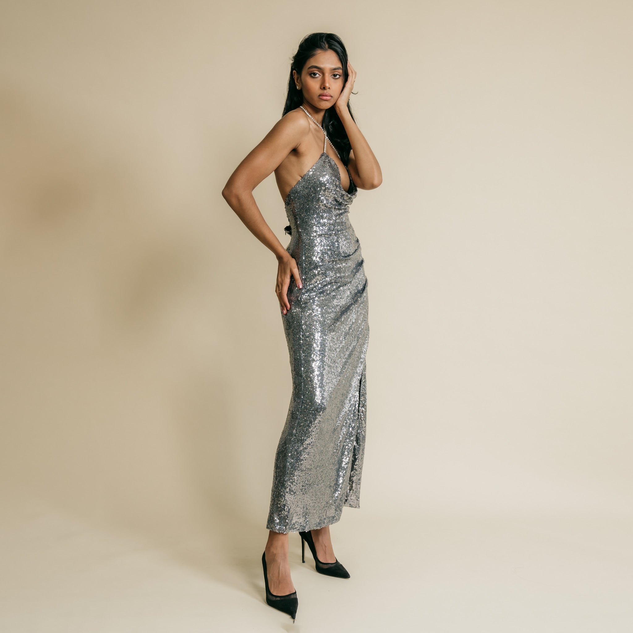 Shiny, grey color, sequin, long dress has on front cross over, rhinestone straps details.