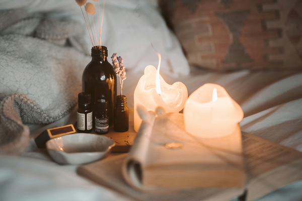 Close-up of candle, books and arometherapy diffusers that help with sleeping