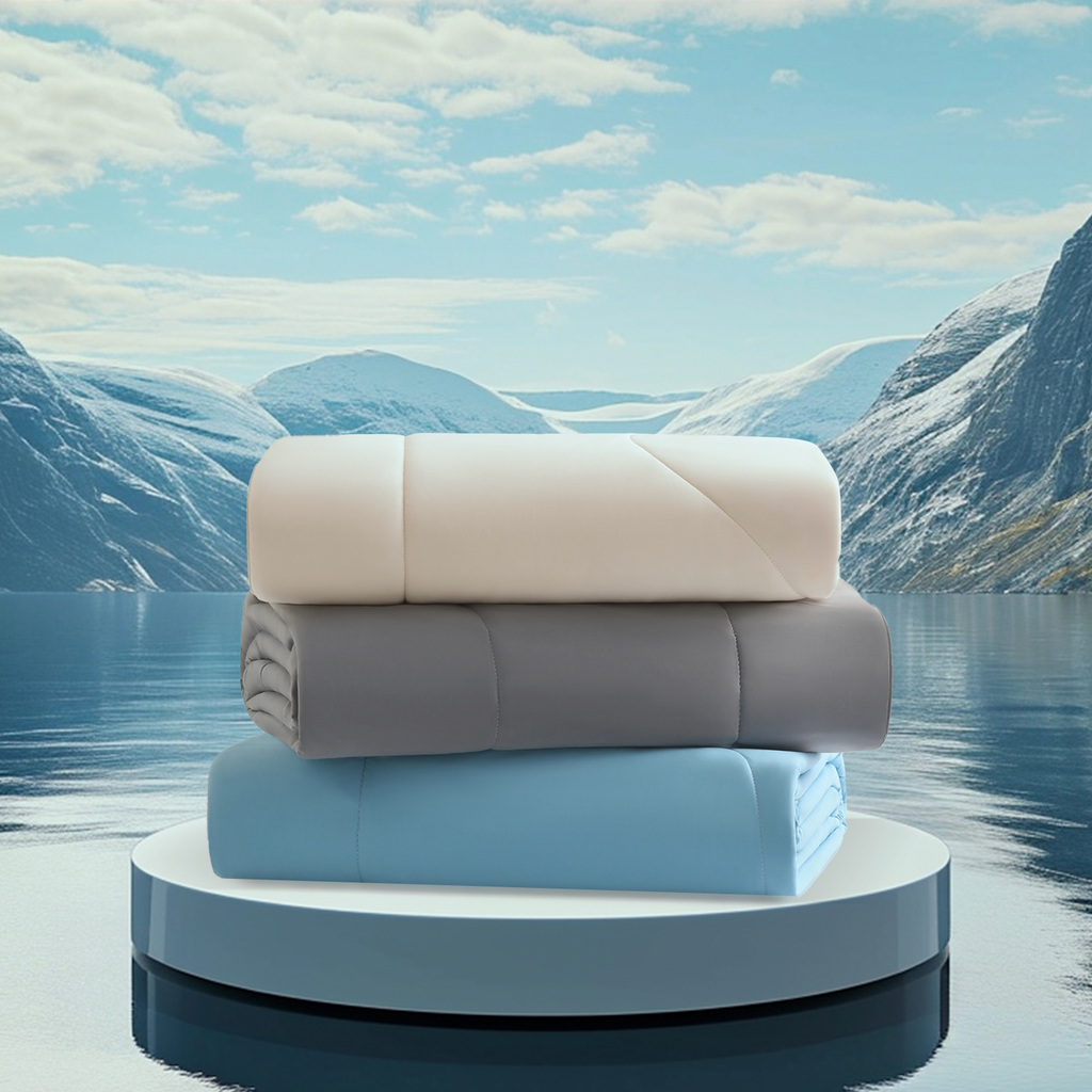 three Evercool Cooling comforter in various colours stacked in front of a mountainscape