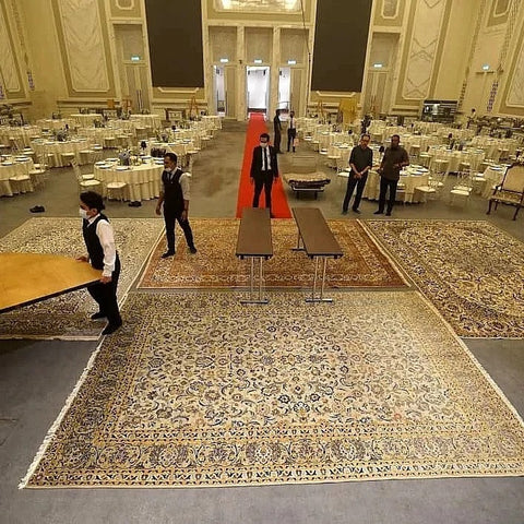 event workers are arranging and setting up carpets on the floor for a presentable official look