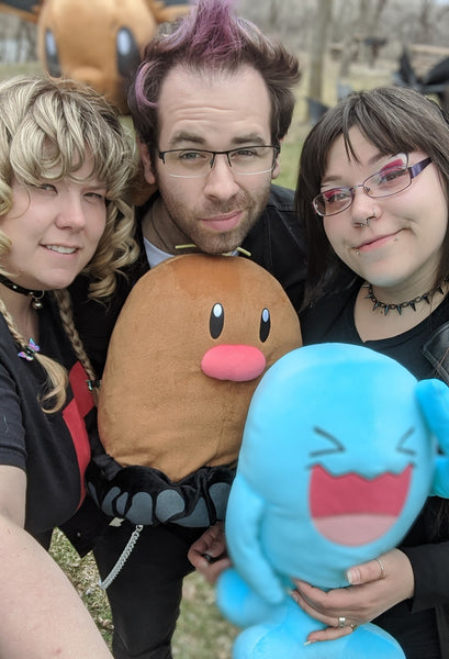 A picture Emily, Hikari and Andrew dressed as Team Rocket Grunts holding Pokemon.