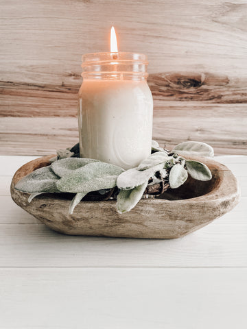 A dough bowl as a wood candle holder for a mason jar candle for farmhouse decor