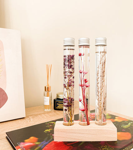 Tubes of flowers submerged on wooden support