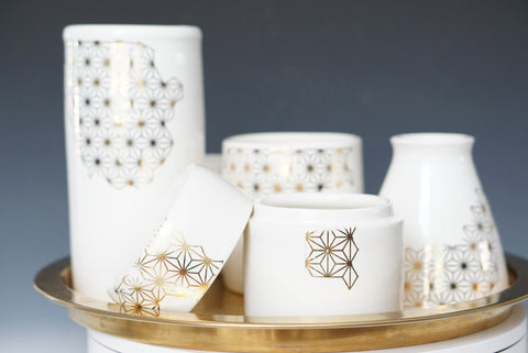 Gold decal wheel thrown vases with a white glaze