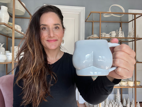Picture of Molly holding the prototype of the new butt mug!