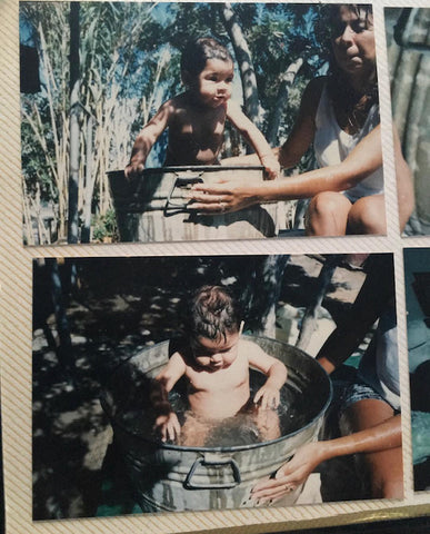 Baby Marla in her abuleito’s back yard, taking a bath