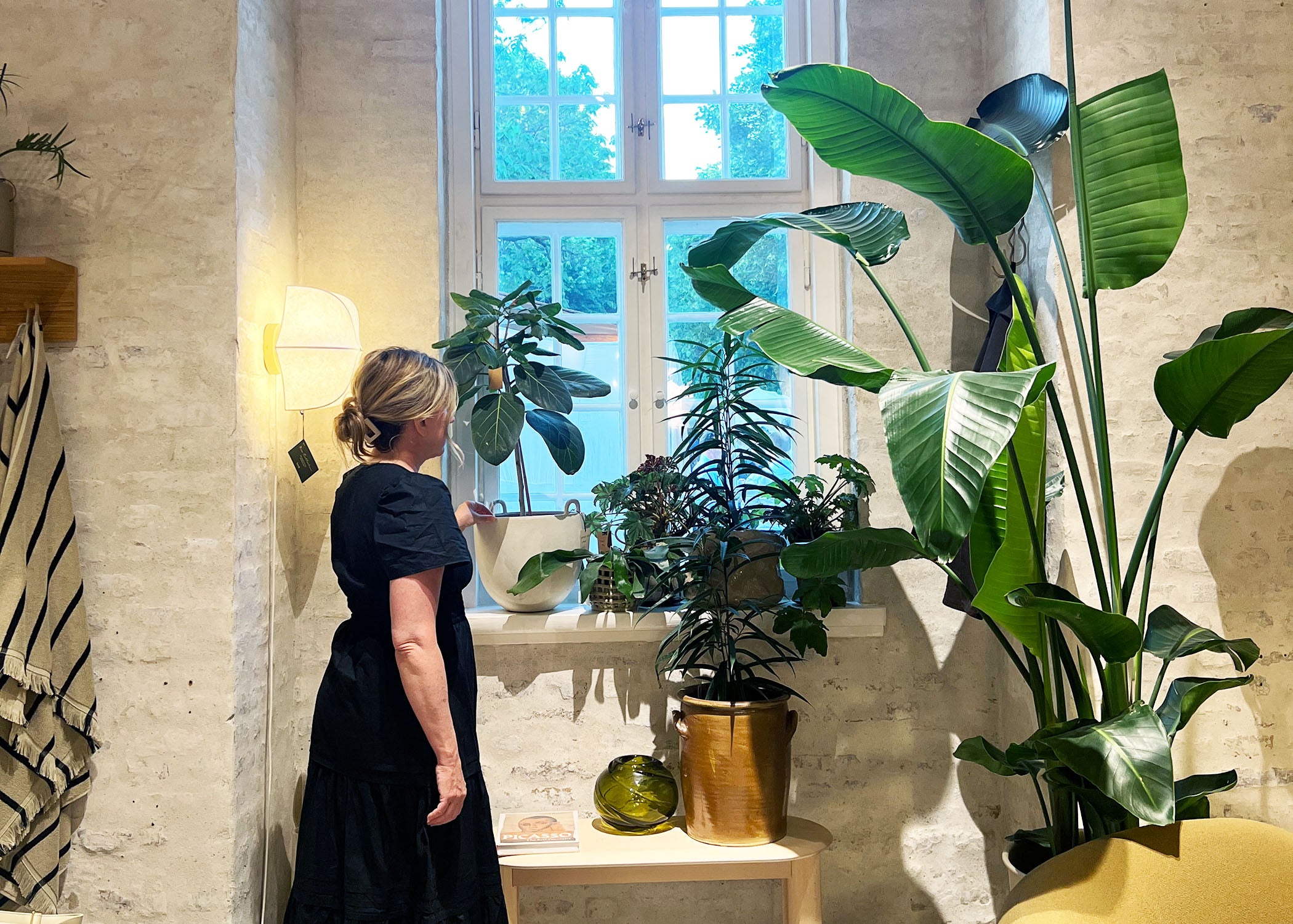 A woman examines decor in the Ferm Living Show Room in Copenhagen, Denmark