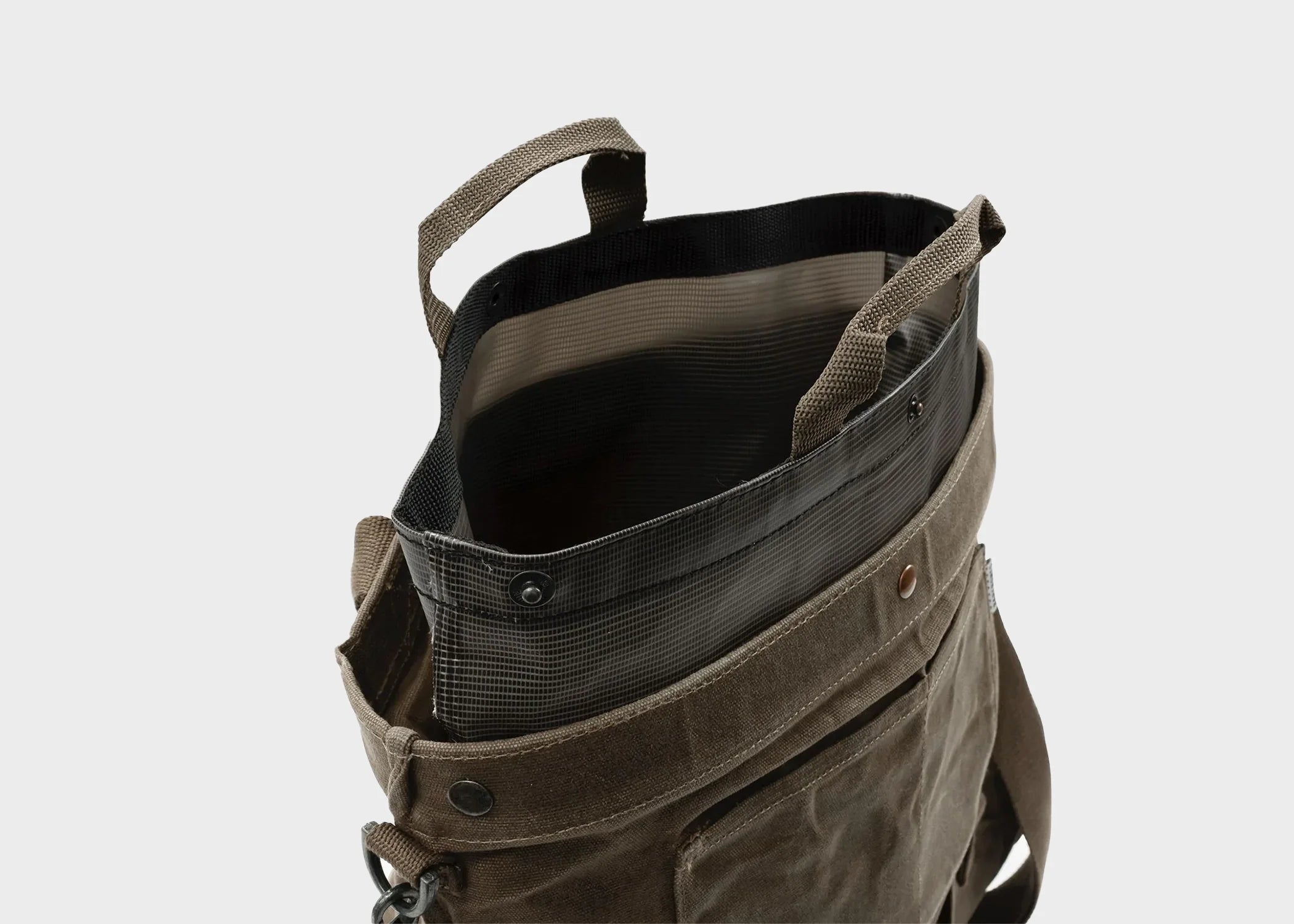 A harvesting and gathering bag by Barebones opened to expose the waterproof interior