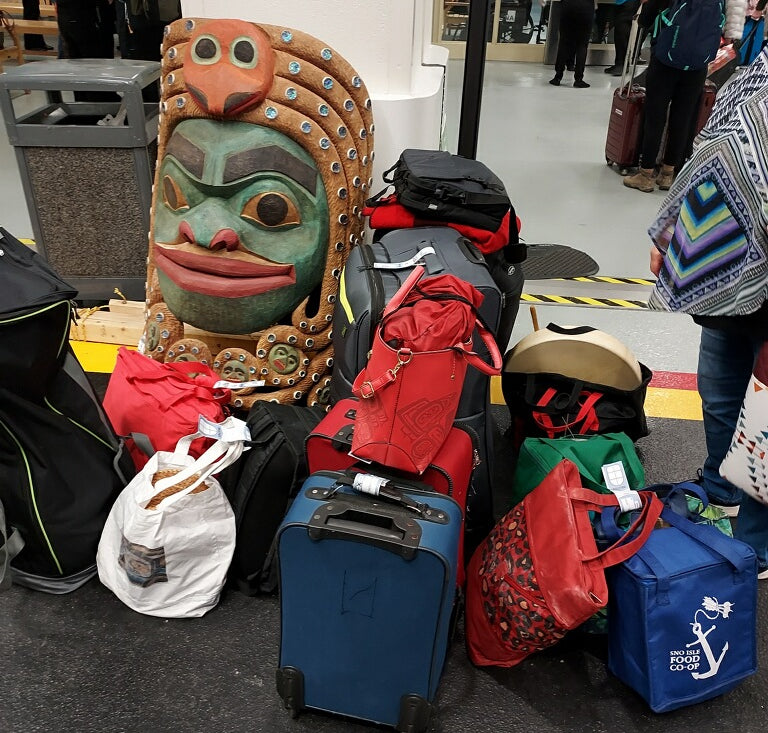 Lots of luggage, carving tools, and a giant cedar mask for Fred and Ivy Fulmer on the way to Alaska by cruise