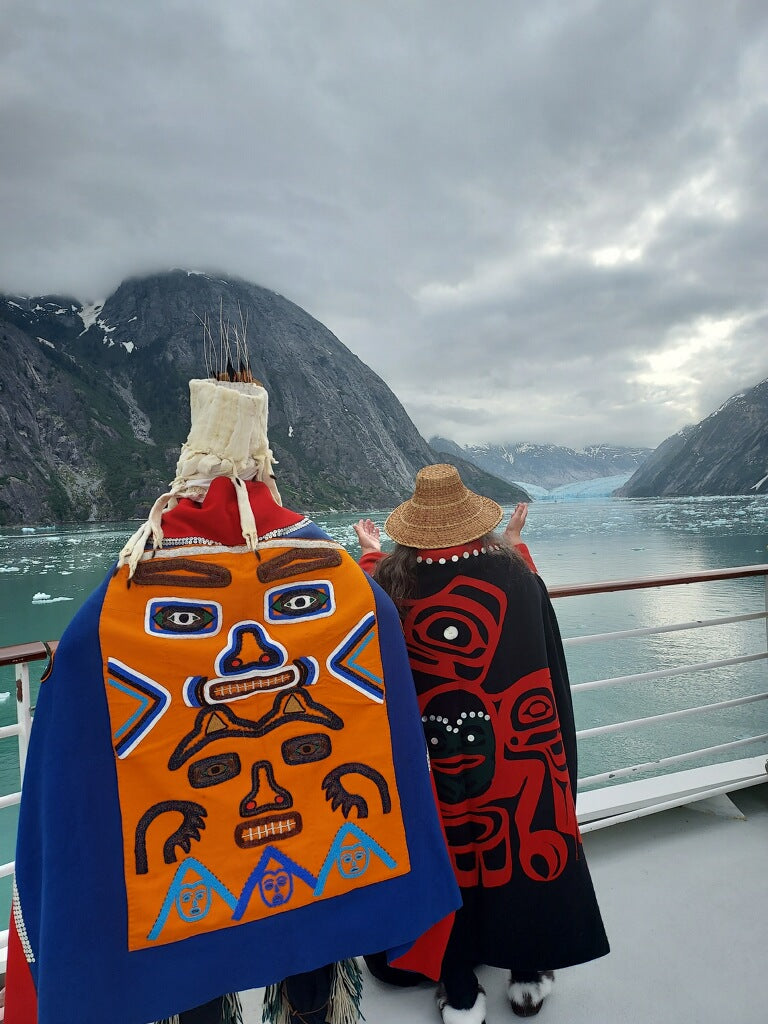 Fred Fulmer Tlingit Artist & Carver with wife Ivy Fulmer on the bow of a cruise ship singing across the Glacier Fields in Glacier Bay Alaska
