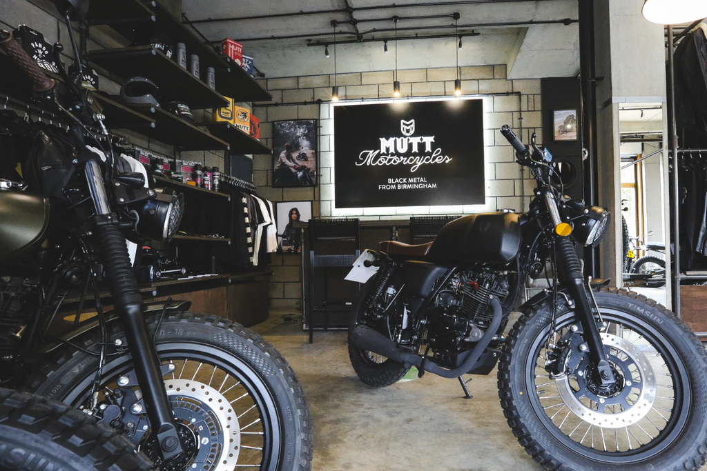 Motorcycles in a store with a desk and till