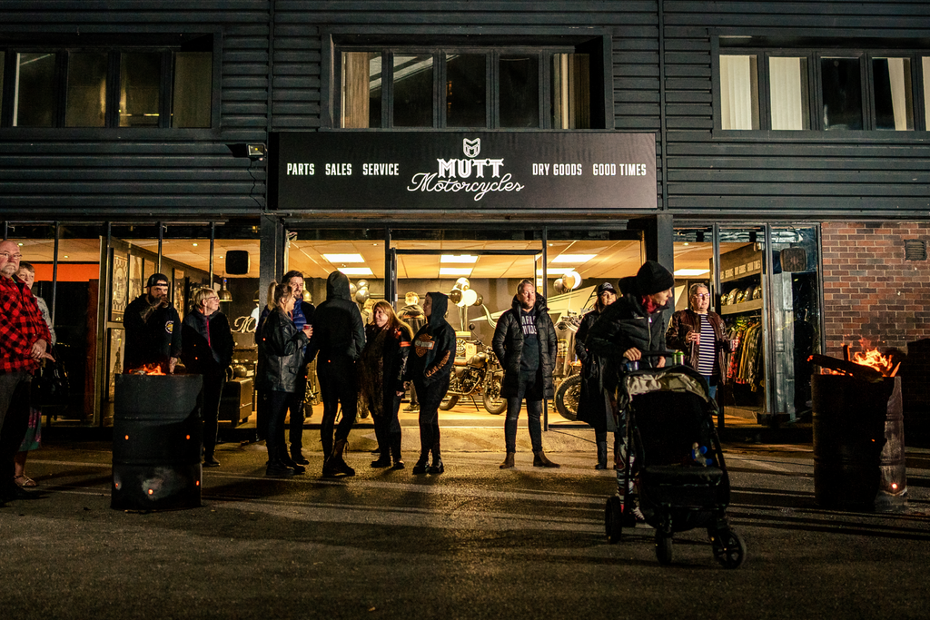 Motorcycle Store Shopfront in the evening with a crowd gathered outside