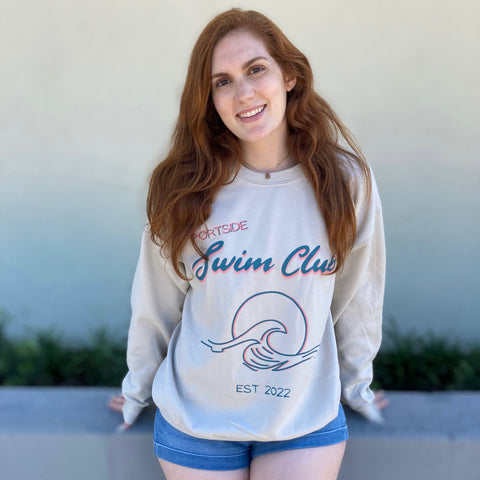 Redheaded woman wearing a Portside Swim Club crewneck