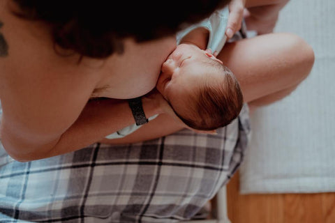 woman breastfeeding newborn baby