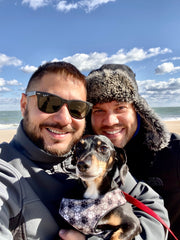 Two dog dads with their Dachshund rescue dog, Tucker