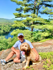 Dog Like Me founder Kara Conway Love and her dog, Walter, sitting on top of a mountain