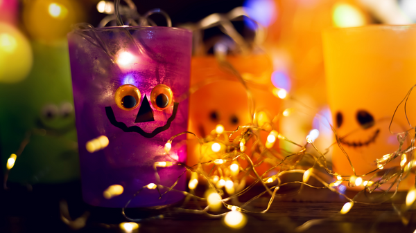 LED fairy lights placed inside painted glass jars with Halloween faces