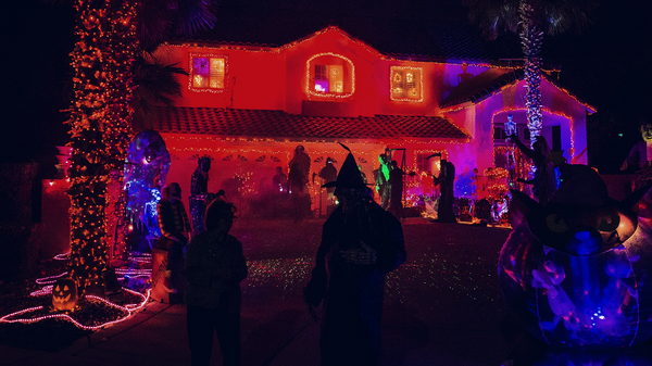 People trick-or-treating at Halloween decorated home